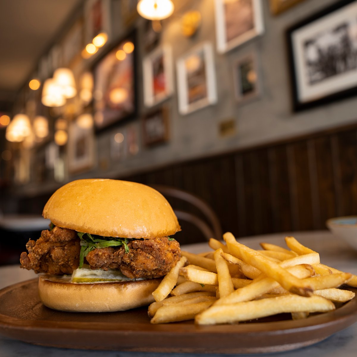 Take a trip to 8th &amp; Ocean this week and dig into our delicious fried chicken thighs, carolina gold &amp; house pickles; served on Cuban bread bun. #NewsCafe #SouthBeach #8thAndOcean