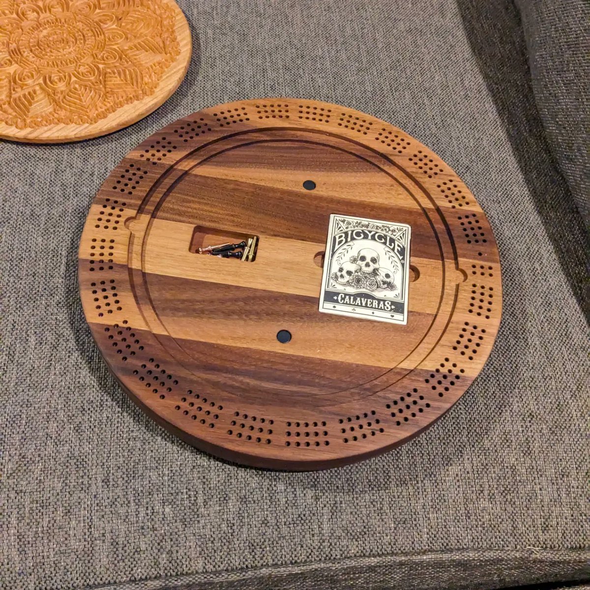 jmauser's tweet photo. Black walnut cribbage board with cherry lid and internal storage. Ravenclaw logo filled with blue mica in epoxy. https://t.co/ydnonFvBzv