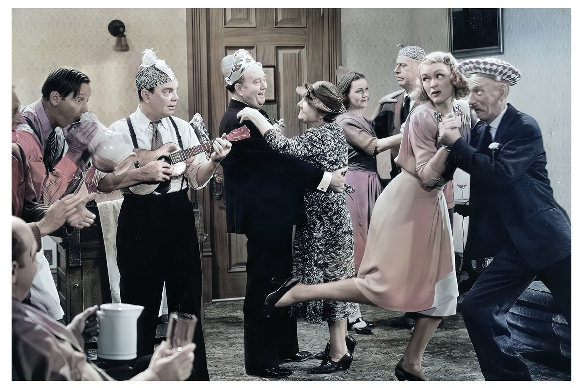 Old photo with ukulele. The girl dancing with the old man is Eve Arden. Taken during the movie 'She Couldn't Say No' in 1940.