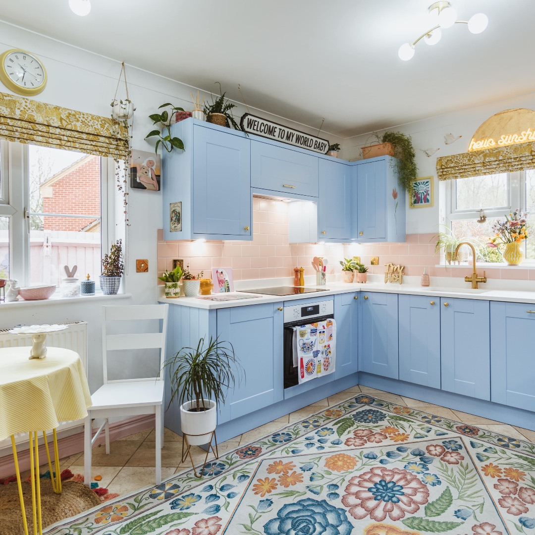 Vibrant blue cabinetry and playful pink tiles blend seamlessly with  eccentric decor and bold patterns in Zoe's eclectic kitchen. This Shaker  cabinetry is given a lively, energetic makeover thanks to the eye-catching, image size:1080x1080