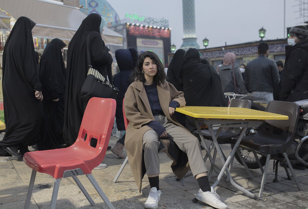 BBCKasraNaji's tweet photo. World Press Photo winner this year: a photograph by Iranian freelance photographer Ahmad Halabisaz.   An Iranian woman sits on a chair in front of a busy square in Tehran, defying the mandatory hijab law a few days after Mahsa Amini’s death. @WorldPressPhoto @Iran https://t.co/W6xMX0GCoe