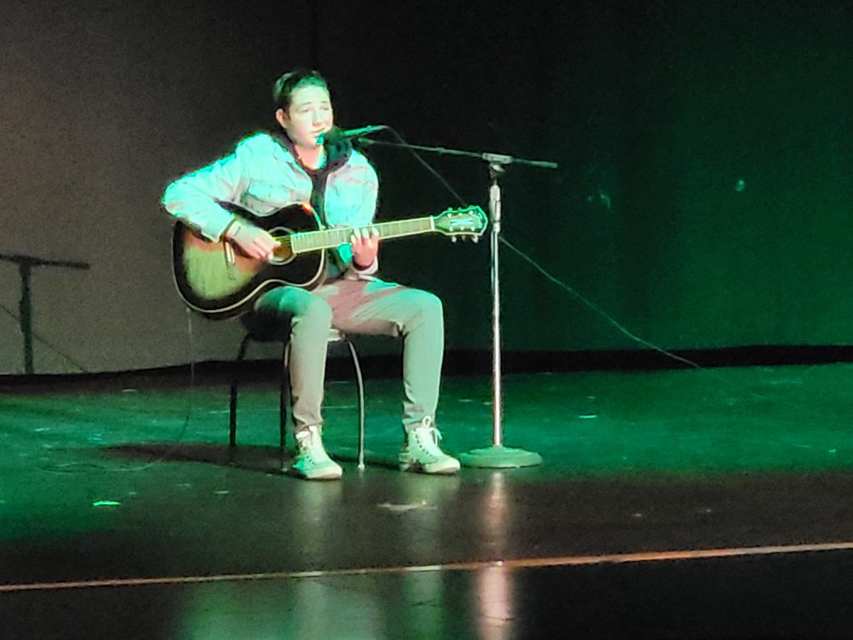 LTI junior Linko Painemilla playing guitar and singing during the JFK Talent Show