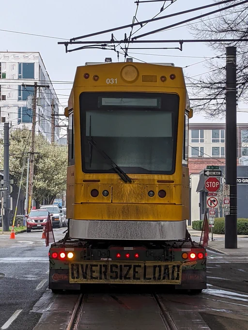 Truck carrying new streetcar.