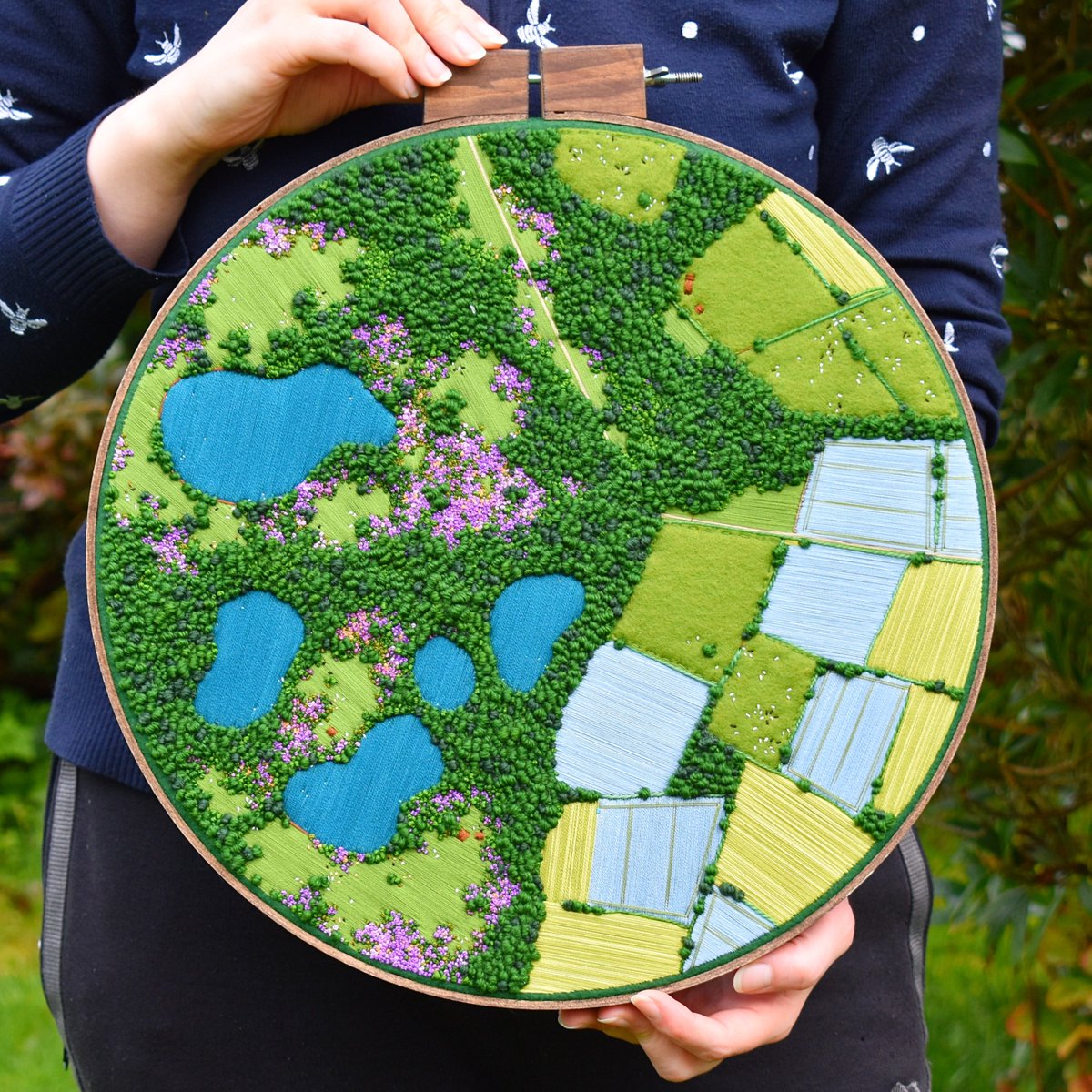 'Its good for the soul (and soothing for the mind)' - a 14-inch aerial embroidery landscape finished last week. Soothing blues, greens and purples in the fields, moorland heather and lakes 💚 and finished with a little country road! #Neurodivergent #ActuallyAutistic #art #artist