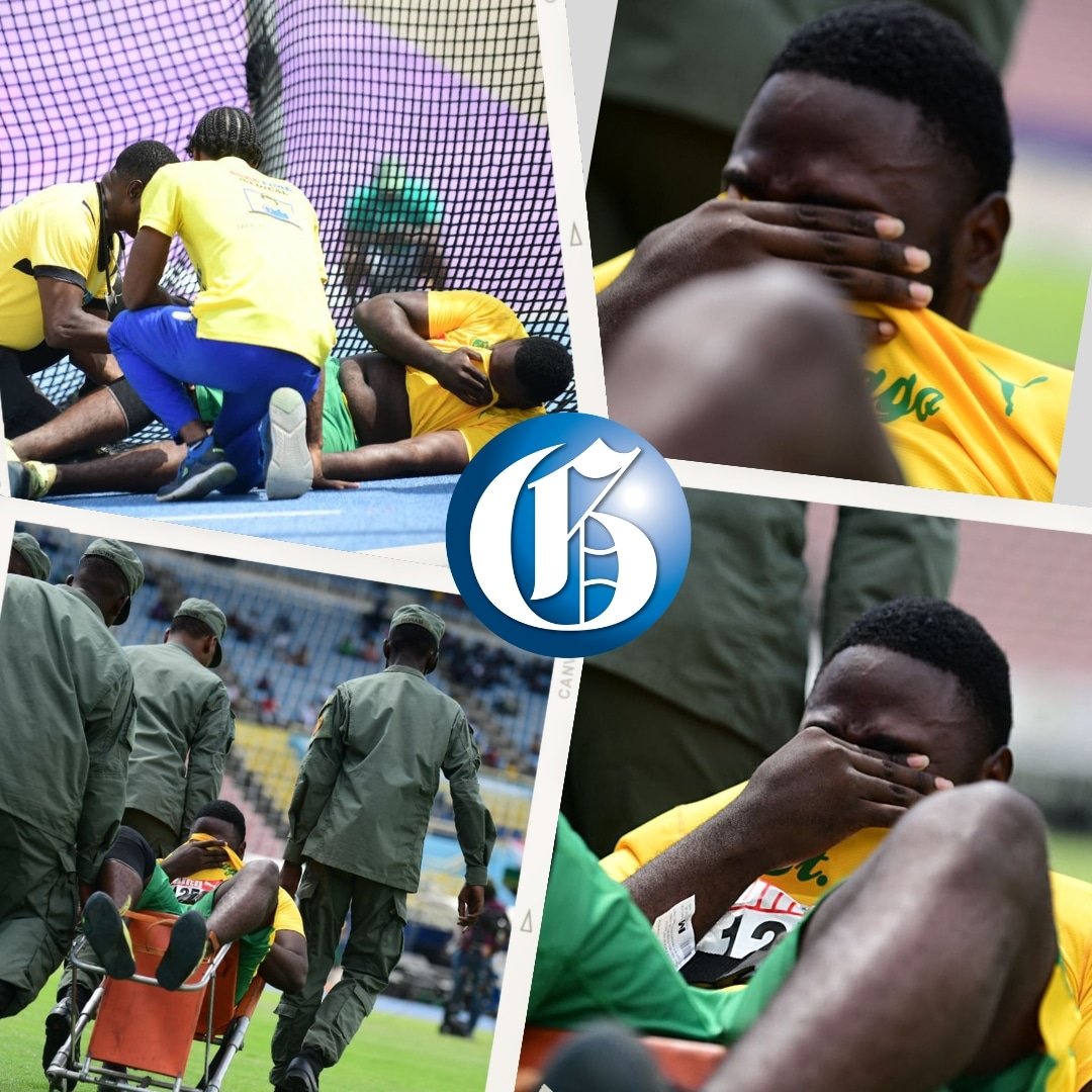 JamaicaGleaner's tweet photo. Inconsolable! St Jago's Shaiquan Dunn is assisted off the field after picking up an injury during the Class One Boys Discus Throw on day two of the ISSA/GraceKennedy Boys and Girls' Athletics Championships at the National Stadium in St Andrew. - @taylor2nd photos  #Champs2023 https://t.co/hMaAsztqtm