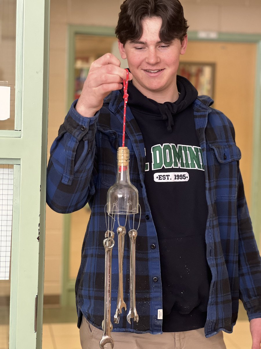 St_DominicCSS's tweet photo. Shop student Hunter shows off his creative kinetic sculpture— wind chimes made from reused material #domspride https://t.co/6tsKjxM6fQ
