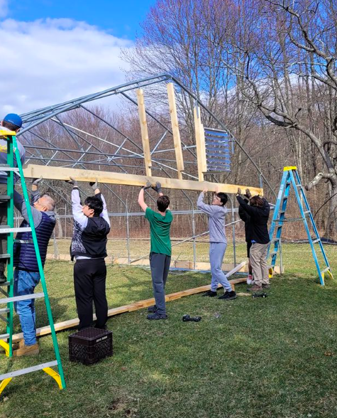 TrinityPawling's tweet photo. The farming team is back in action for the spring season! This week, the boys continued construction on the end walls of their new moveable greenhouse, using lumber that they milled themselves on the sawmill. Well done, gentlemen! #EthosOfEffort https://t.co/oAFJDnoWK7