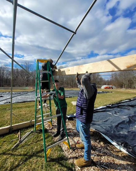 TrinityPawling's tweet photo. The farming team is back in action for the spring season! This week, the boys continued construction on the end walls of their new moveable greenhouse, using lumber that they milled themselves on the sawmill. Well done, gentlemen! #EthosOfEffort https://t.co/oAFJDnoWK7