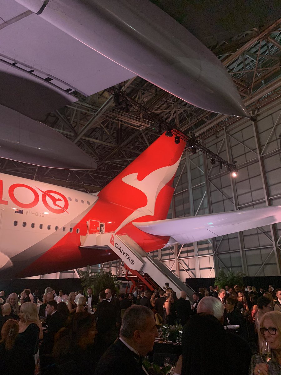 AnthonyTravelEd's tweet photo. Kylie Minogue the surprise guest at tonight’s Qantas 100th anniversary dinner at Sydney Airport. Her opening song? The less surprising Qantas anthem, ‘I Still Call Australia Home’. @TravellerAU @qantas https://t.co/3WhuzghL8n