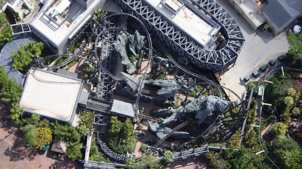 bioreconstruct's tweet image. A nearly straight-down aerial look at a train launching out of the paddock, at VelociCoaster.