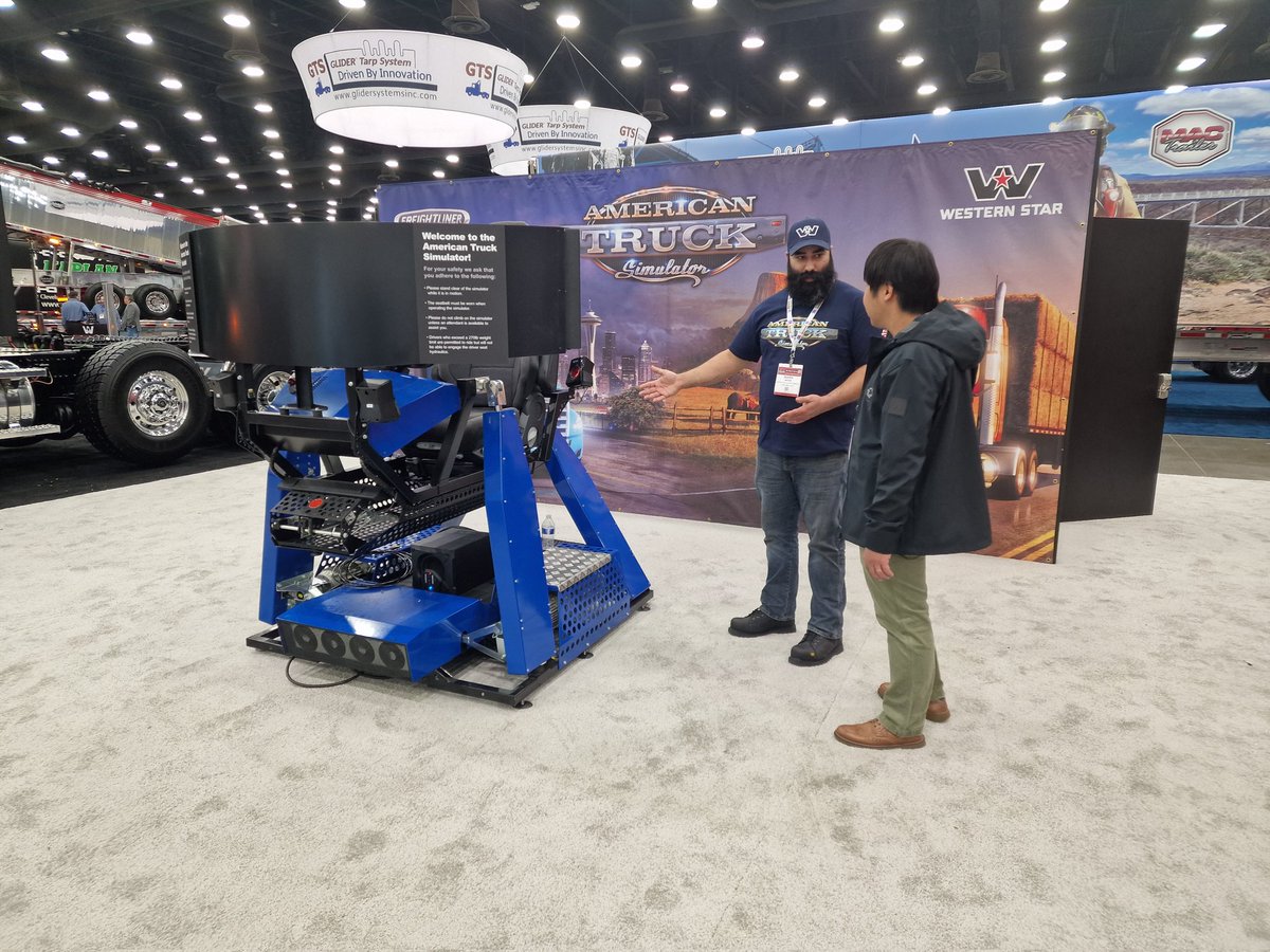 SCSsoftware's tweet photo. The second day of the #MATS2023 expo in Louisville, Kentucky is about to begin! 🙌

If you're attending this amazing event, make sure to stop by at the @DaimlerTruckNA booth where we have one of our 4D Motion Sim ready for you! 🎮

See ya there! 😉

#StarNation #WesternStarTrucks #FreightlinerTrucks #BestCommunityEver