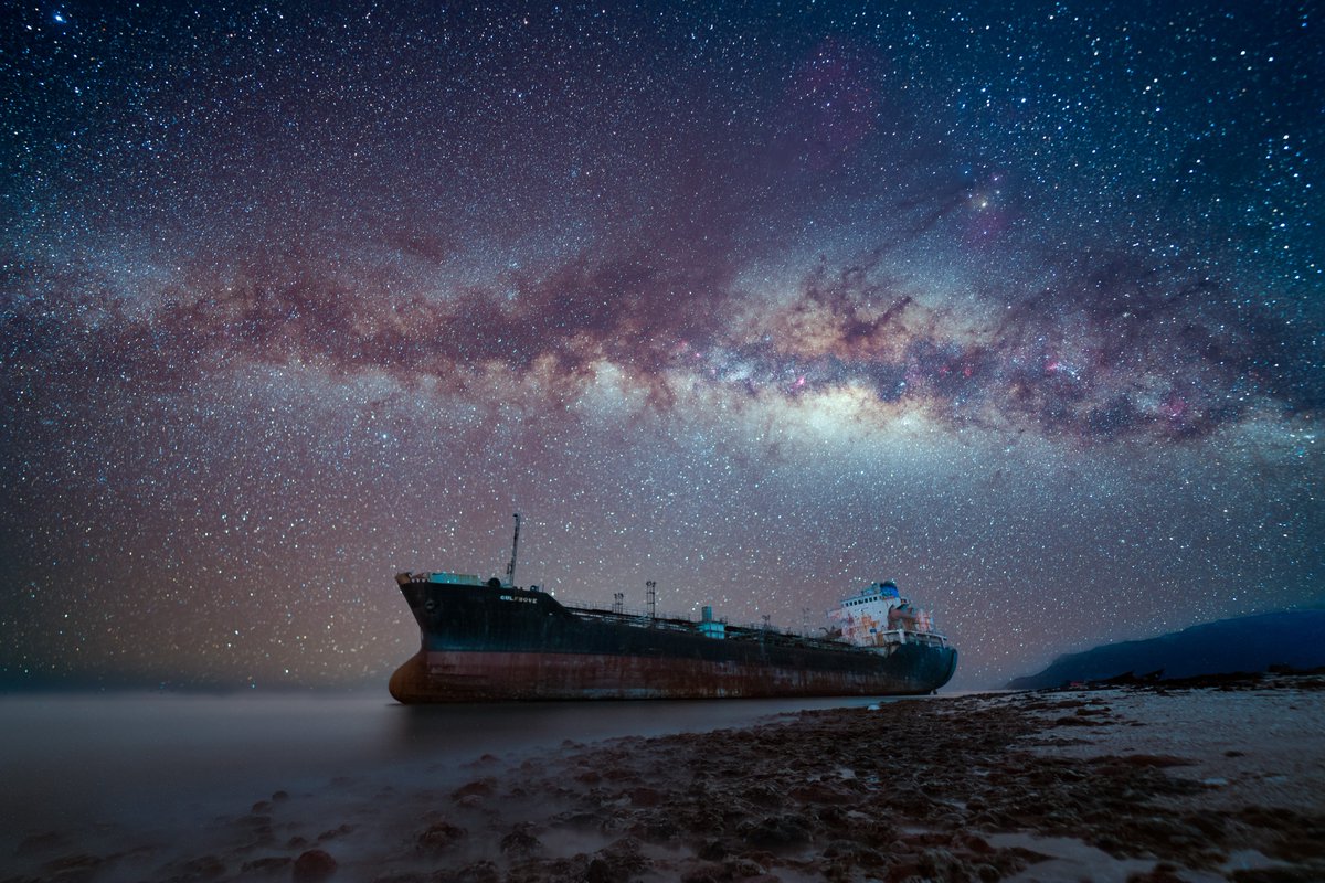 Advil's tweet photo. a shipwreck on socotra island! in my quest to photograph the darkest skies in the world i headed to yemen and camped for a week to shoot the stars. had so much fun exploring this incredibly diverse island. https://t.co/tPfjhdkEKw