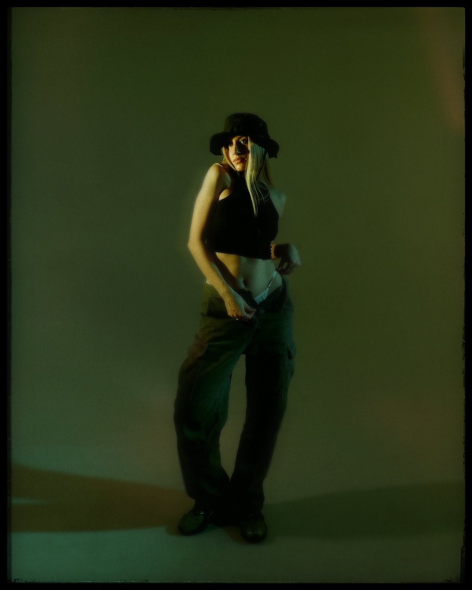 • promt: extremely adorable girl in wide pants, wearing a panama hat, standing in a relaxed pose on a solid green background, texture of glow and roughness, film fashion photography, ultra realistic portrait, style of photography by rastoltceva anna 

gn ☁️
