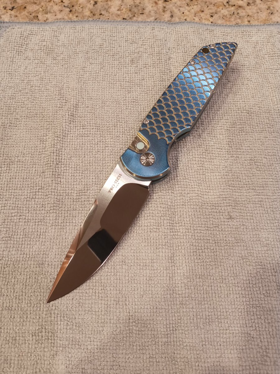 Successful start to the new job called for a new knife.

This is the Pro-Tech TR-3 OTS. Handles are titanium fish scale with a pearl inlay on the button lock.

Blade is a Mike Irie mirror polished nightmare grind in CPM154 steel.

I call her Vera...