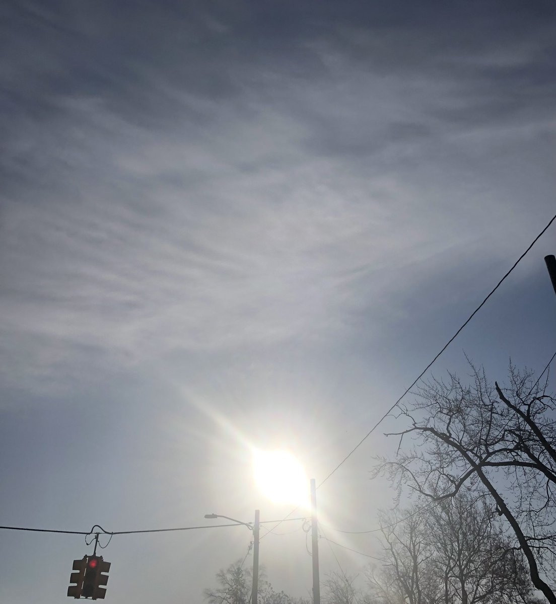 #the #glowing #sun #powerful #aura #halo #sunrays #bright #sunlight #up #high #above #pale #blue #sky #clouds #dark #grey #gray #light #buds #trees #branches #leaves #utilitypoles #powerlines