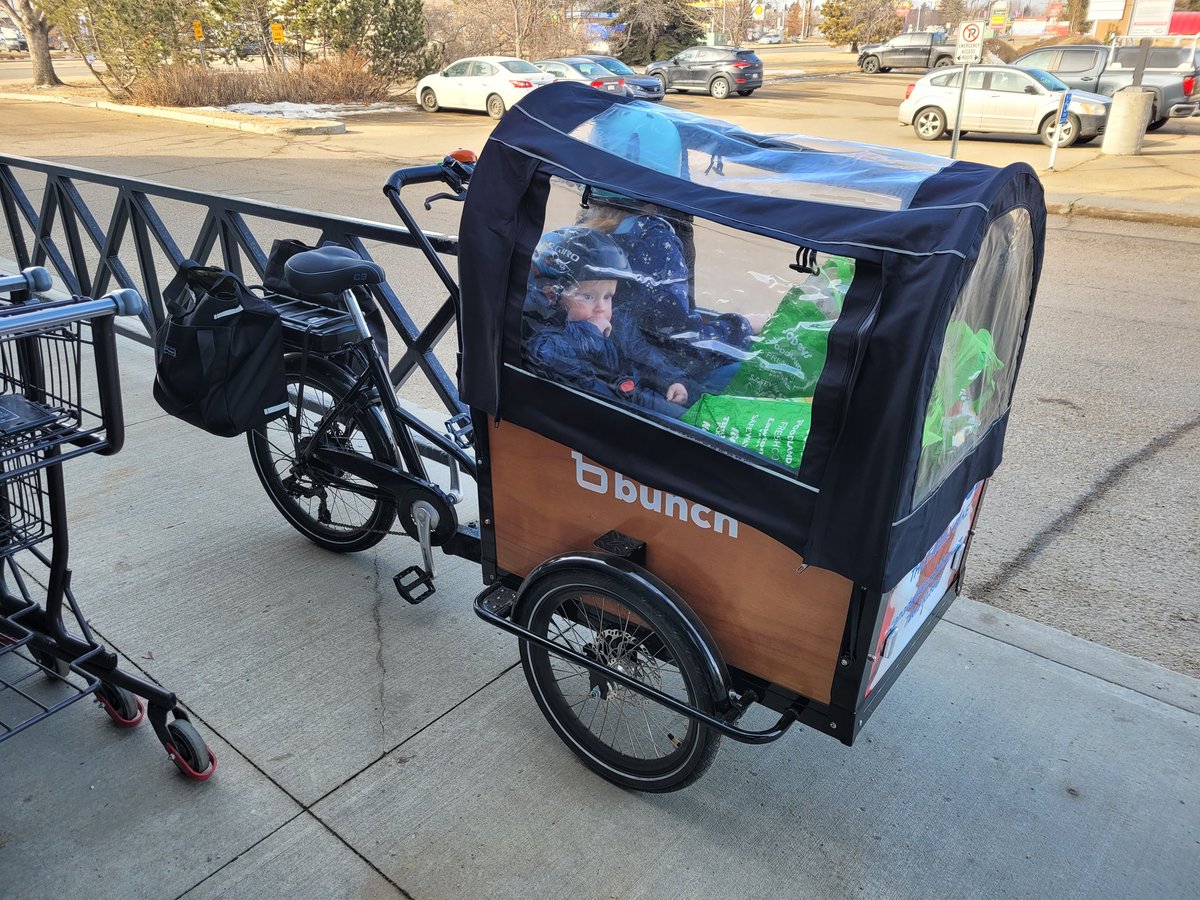 Grocery shopping for a family of 6?  While living in the suburbs?  Without a car?  

Easy with a cargo bike.  Holds 2 kids plus groceries.  And you get prime parking 😆

#carfree #CarReplacement