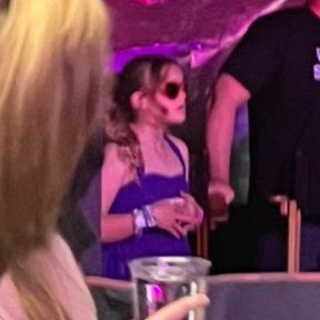 tswifterastour's tweet photo. 🚨| Taylor Swift gave her signed ‘22’ hat to Selena Gomez’s little sister, who is dressed as “Speak Now Taylor” tonight! 🥺💜

#TSTheErasTour #ArlingtonTSTheErasTour https://t.co/OVS8Lgpr4Q
