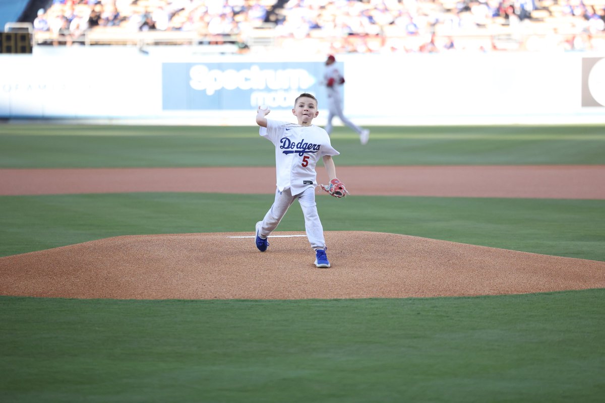MLB's tweet image. Charlie Freeman throwing out the first pitch to his dad Freddie has us in all our feels. 🥺