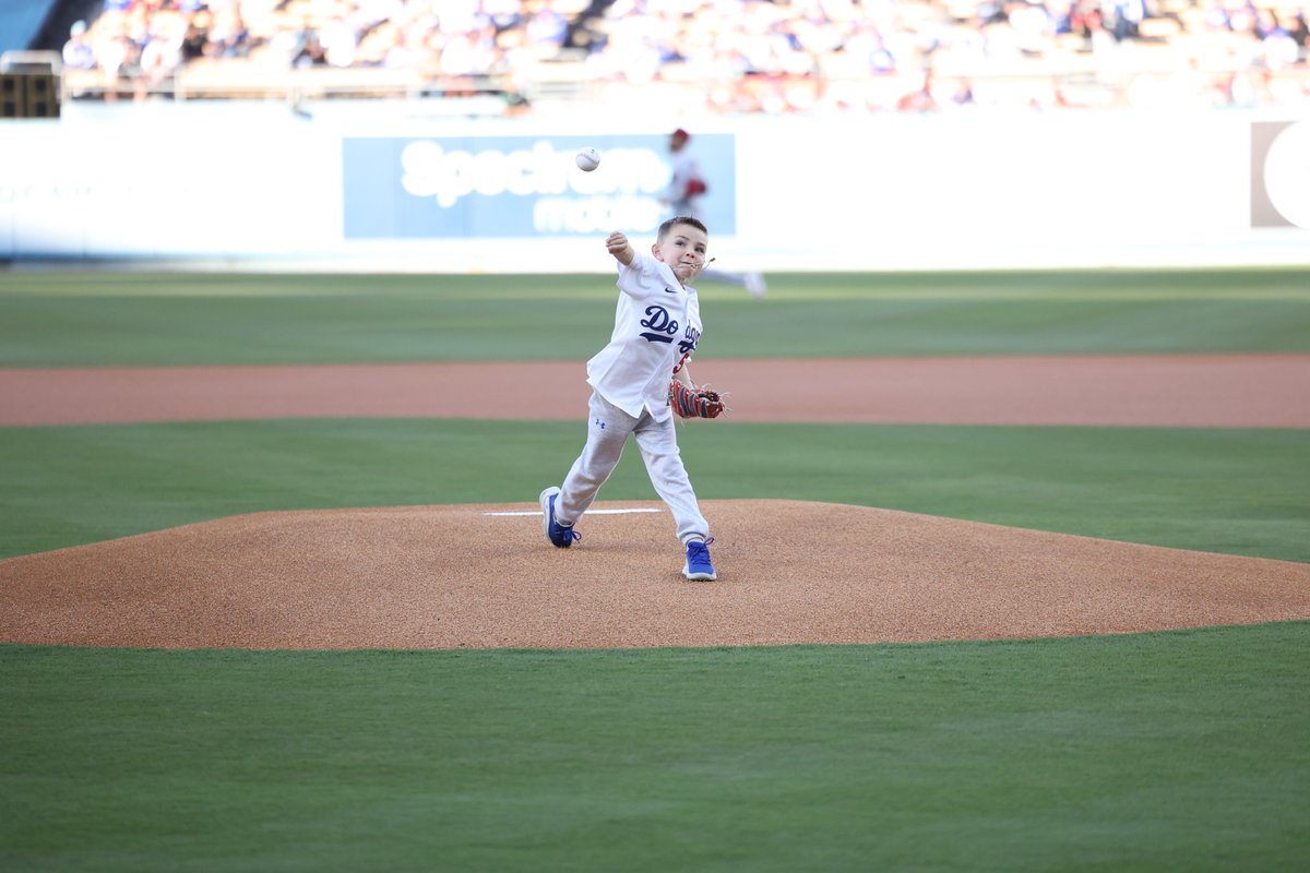 MLB's tweet image. Charlie Freeman throwing out the first pitch to his dad Freddie has us in all our feels. 🥺