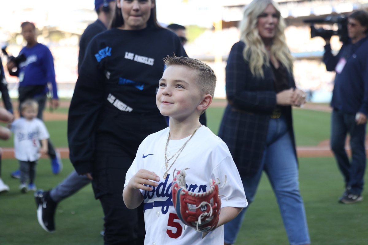 MLB's tweet image. Charlie Freeman throwing out the first pitch to his dad Freddie has us in all our feels. 🥺