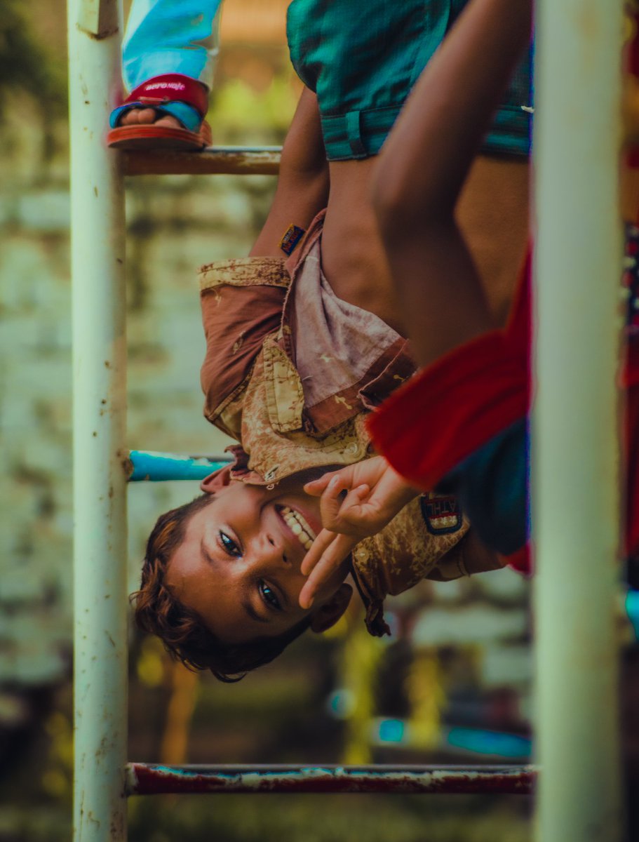 In the evening, I took the camera and went to the park.
The children there jumped even more when they saw the camera in my hand. This kid climbed the pole and hung upside down, then I took a picture of him.
.
.
Location : Pirmahal, Punjab, Pakistan 
.
Photographer : Saad Jabbar