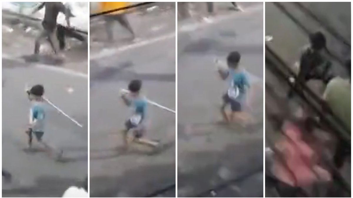 This kid. He has no idea what he is doing. He just picked a stick from the middle of the road, risking to be hit by stranded objects &amp; started running, though he could barely, in the direction of the mob he is part of. Next he was looking for a soft target to use his new toy.