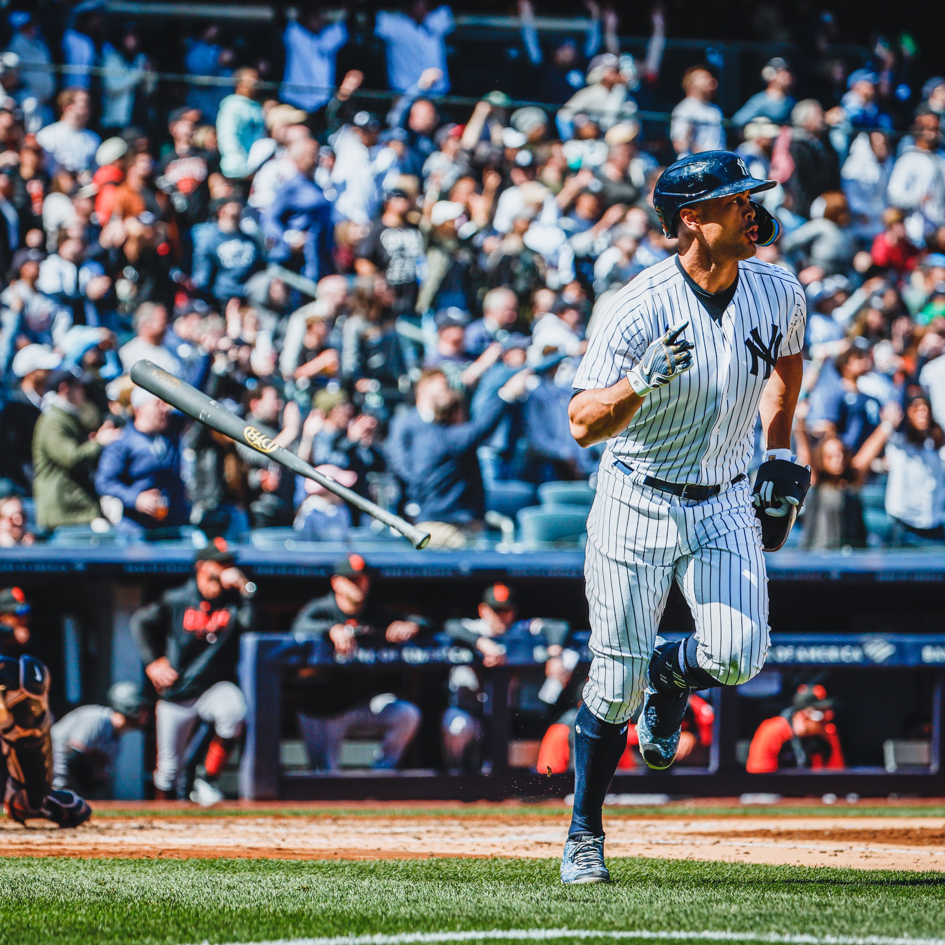 Giancarlo Stanton flips his bat after hitting a 485 ft home run. 