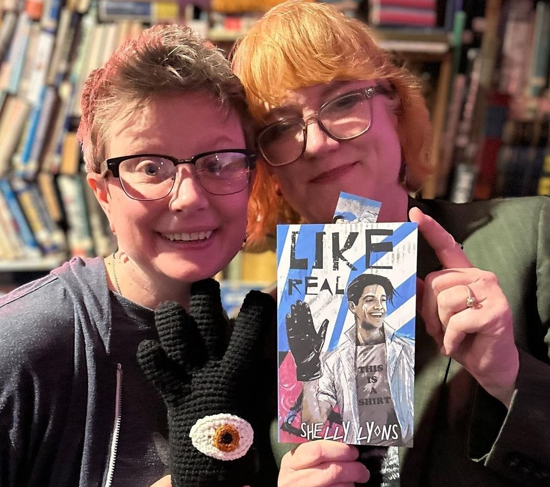 dollterror13's tweet photo. 2 gals @ a book reading. On the left is @AdrianRoseLeon1, director, puppeteer, fabricator, drummer,  singer. The one on the right wrote a good book, has too many cats &amp; did a nice job of reading on 4/1/23.  
#creativewomen #bookreading #likerealbook #femalehorrorauthor https://t.co/LdLOqrhu4I