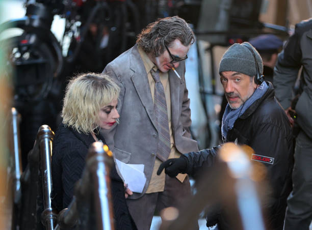ladygaganownet's tweet photo. Lady Gaga, Joaquin Phoenix, and Todd Philips on the set of “Joker: Folie à Deux” in New York. https://t.co/YYumFau7LE