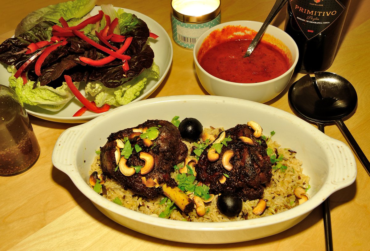 Cast-Iron Cook-Off! Lamb Haneeth. A fabulous Yemeni dish - slow-cooked lamb shanks marinated in eastern spices, served on a bed of wild rice with toasted nuts and flat-leaf parsley....with a side of sweet red pepper sauce and some fresh salad leaves. Very tasty!