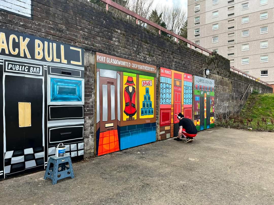Finishing touches by Tragic O'Hara @RIGArtsGreenock to the #PortGlasgow Bay St Shops co-designed community mural. 

@RIGArtsGreenock project Funded by <a href="/rivclydehomes/">River Clyde Homes</a> Cycling Scotland’s Social Housing Fund.

#Inverclyde #Scotland <a href="/inverclyde/">Inverclyde Council</a>