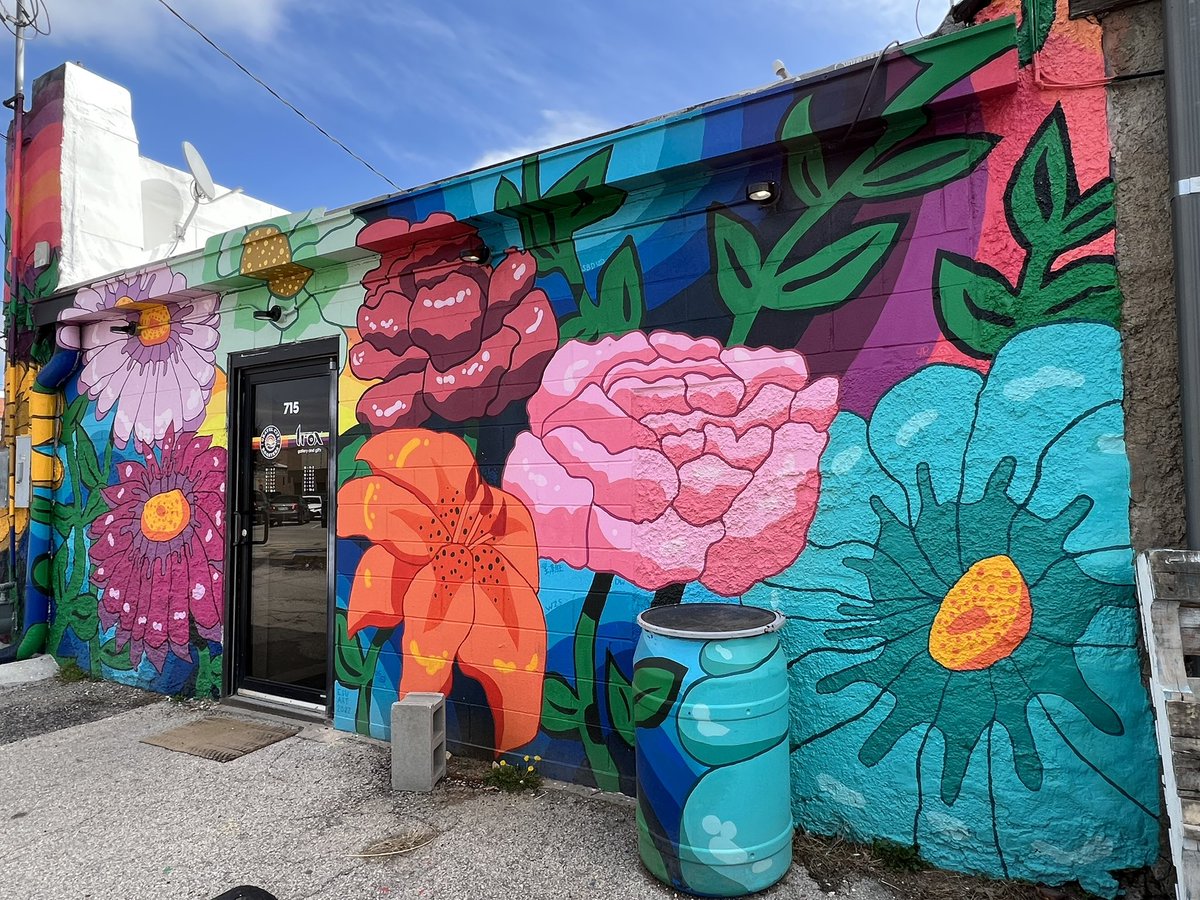 Spring blooms welcome visitors at Gravel City Roasters cafe - the trash can is painted to match the mural!  #MuralMonday 

🌺 Share a spring-themed mural in your collection today. #mural