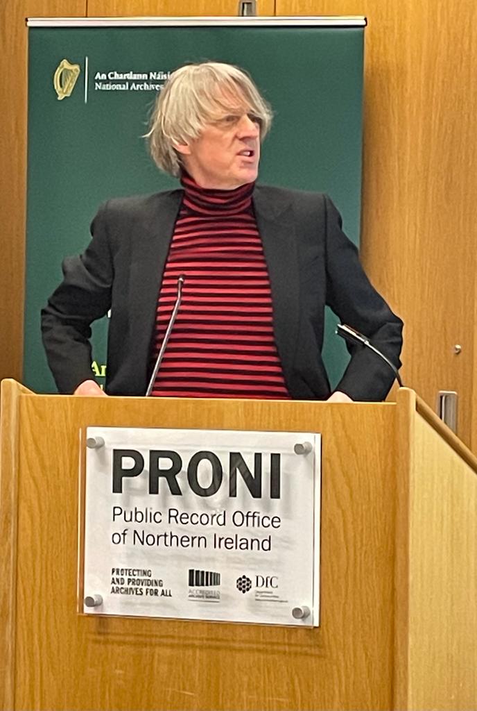 NARIreland's tweet photo. Keynote speaker Glenn Patterson @Heresmehere (writer and director of the Seamus Heaney Centre @QUBelfast) reflecting on where he was #3studios and what questions he was being asked in the week leading up to 10 April, and May and June @DeptCulturelRL @PRONI_DFC #GFA25 https://t.co/r03rT9aqgF