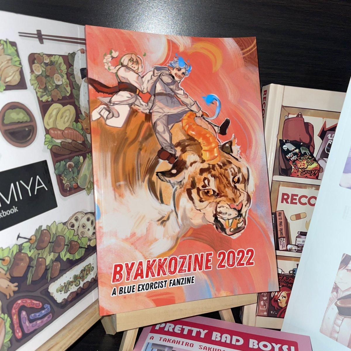 <a href="/ByakkoZine/">ByakkoZine: A 2022 Blue Exorcist Fanzine-CLOSED</a> is the first printed zine I have ever contributed to, which is why it gets to be front and center on my zine shelf ✨

Thank you mods and fellow contributors for this wonderful experience I’ll always cherish❣️🐯