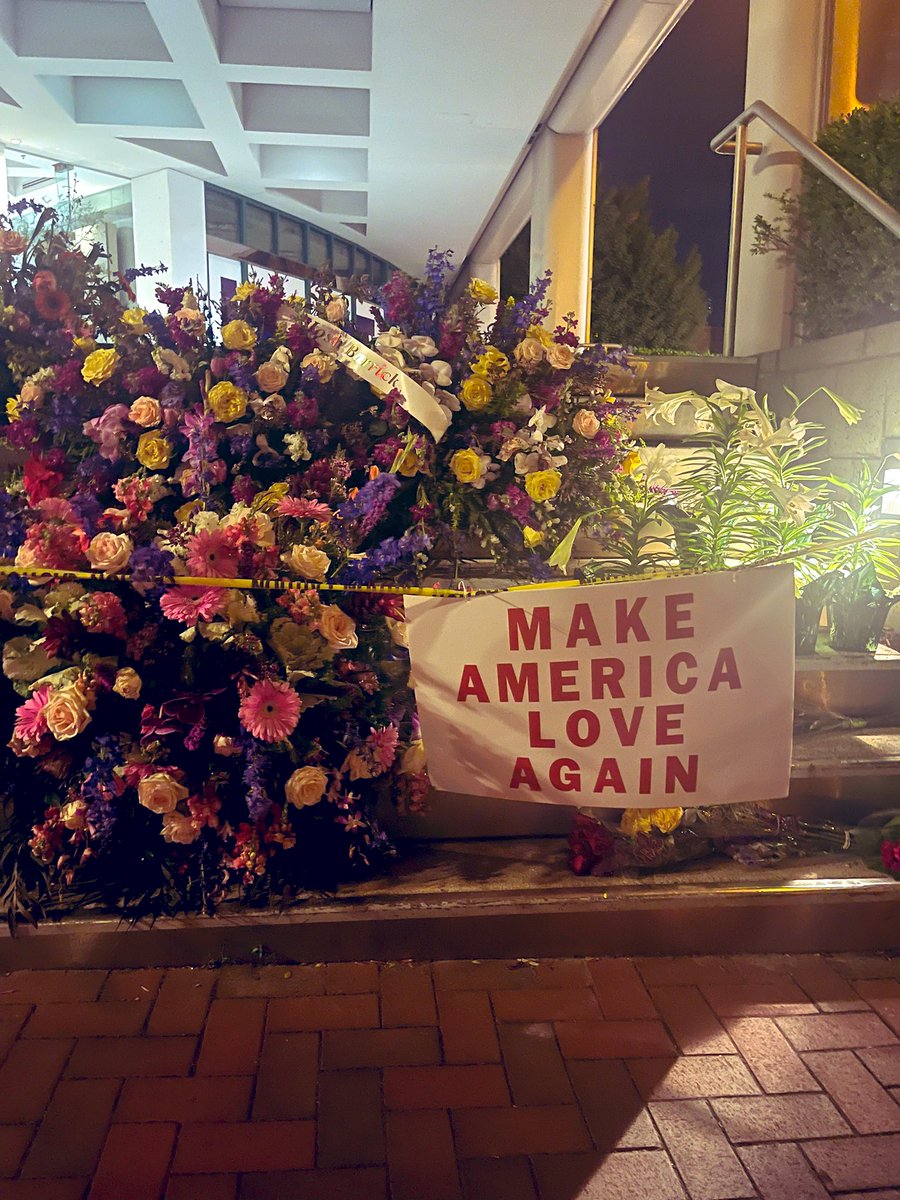 doctorjimmyky's tweet image. Makeshift memorial at site of Louisville mass shooting. A motto of love and inclusion stands in stark contrast to a similar motto of hatred and exclusion. Can we stop ourselves from sliding further into divisiveness &amp;amp; enmity? Can we value human life over weapons of war??