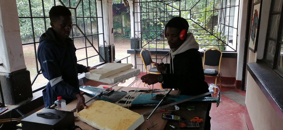 MicroMek_LTD's tweet photo. MicroMek developers & Engineers Tresfore Gawani & Allan Mpate are keeping warm through the #Blantyre weather, working on a local container mold that will carry medicine on one of our new #eVTOL #Drones #TheFutureIsUnmanned #Drones4Health #ProjectFlyingThings https://t.co/rKUOqq8sOp