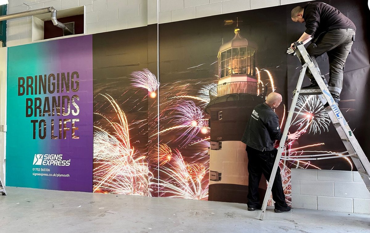 The team managed to squeeze in a little light wallpapering in between vehicles today. #wallpapergraphics #signsandgraphics #vehiclebay