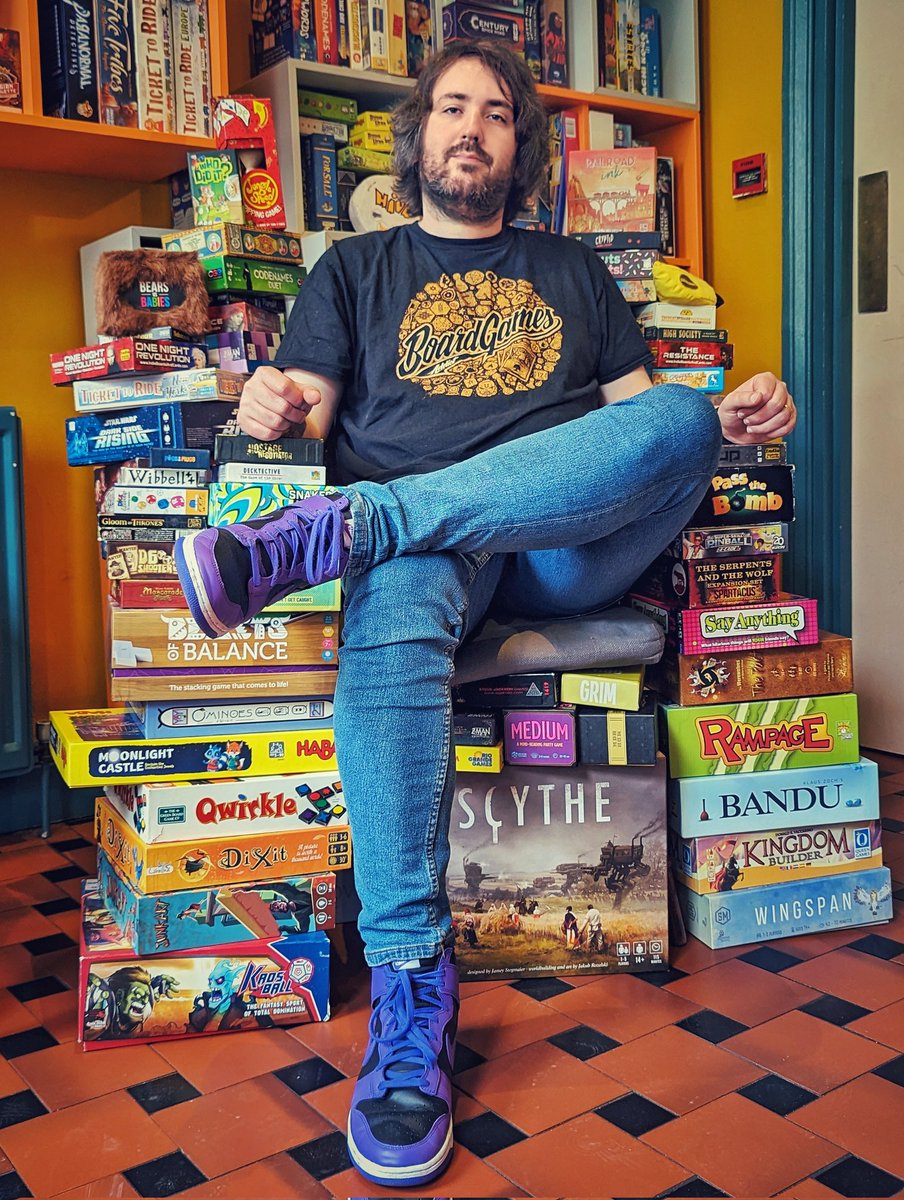 MeeplePerk's tweet photo. When people asked what we were doing with the games we informed them we were building a throne out of them. 

As promised, here is our Throne of Games. 

In other news, we are open tomorrow and Saturday selling games from the collection, 12pm-6pm. https://t.co/UEqno25pmT
