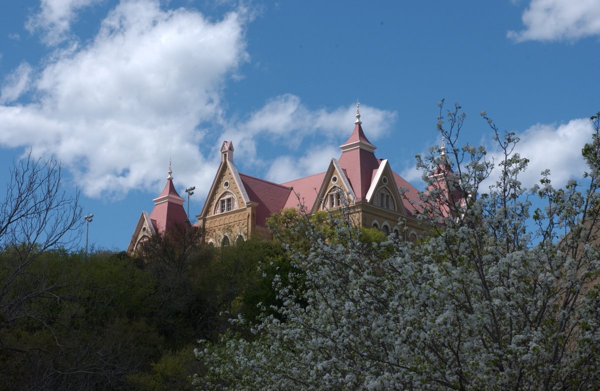It's a beautiful day to be a #txst Bobcat. 
Image of Old Main behind a flowering tree, taken in 2003.

#txstUnivHistory from the University Archives