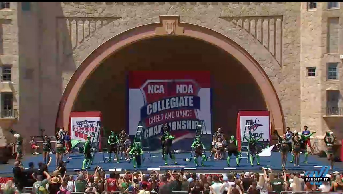 CheerTheory's tweet photo. Utah Valley University Game Day Division IA feels like a fever dream. Men in green suits. Ladders. Why not! 

#NCAnationals https://t.co/1itBMz3nG6
