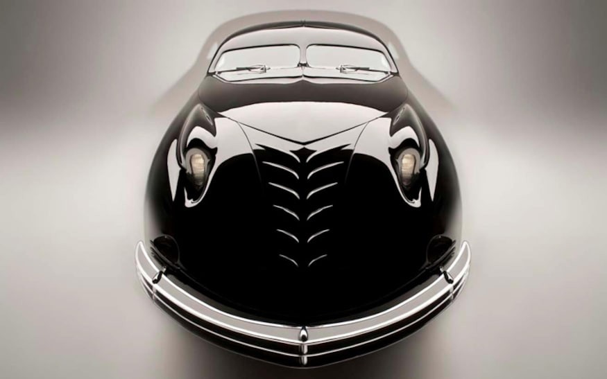 but menacing grille. The doors operated with electric pushbuttons instead of door handles, making it even more streamlined in appearance. As long as the car was, the more shocking dimension was the 6″+ width that could accommodate four people in the front row, one to the left of