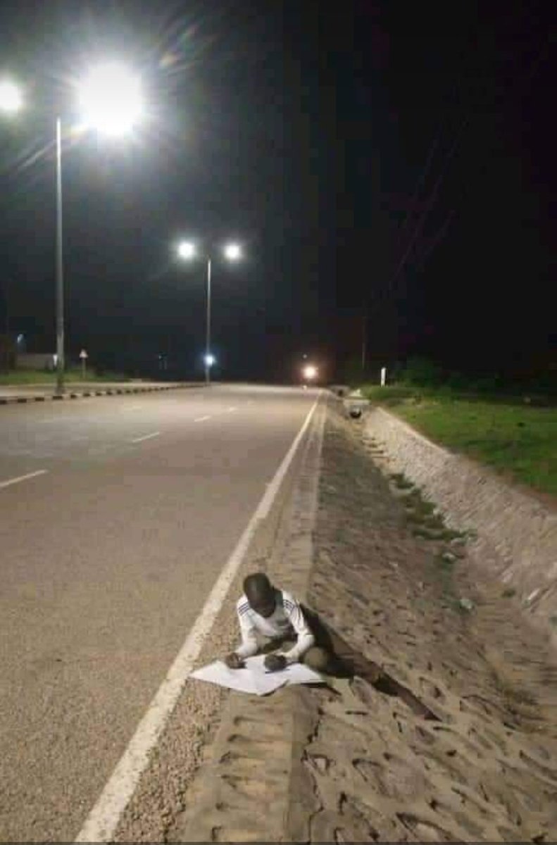 Jillot1's tweet photo. Because his parents can't afford to pay electricity bill due to high price,he went for plan B(using street lights).Our leaders,if you really believe education is basic need and every child to access subsidize the cost. https://t.co/Ugs6J6HvET