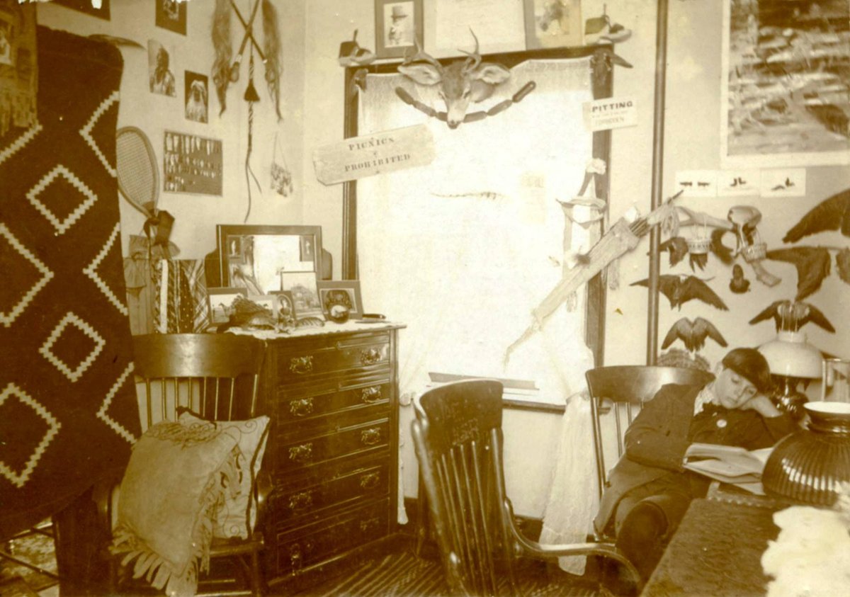 An 1898 Academy student studies in his dorm room under a bird display. #ArchivesForTheBirds #ArchivesHastagParty