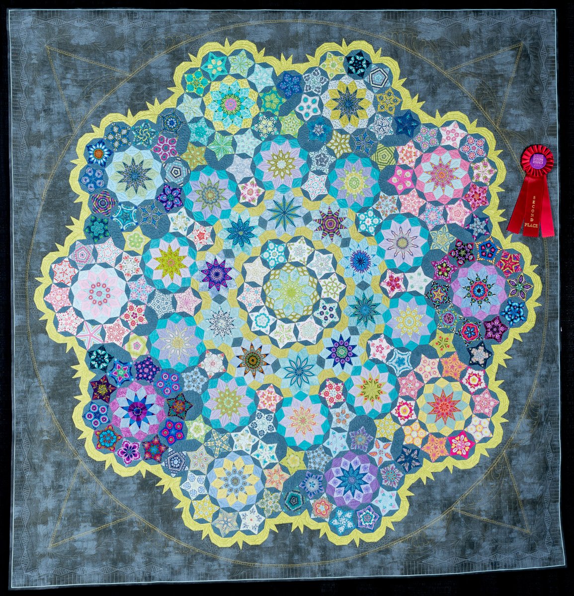 WIQuiltShow's tweet photo. "Yabba Dabba Done!" created and quilted by Susan Nelson of Byron, Minnesota, second-place winner of the 2022 Quilt Contest, Machine Quilted Pieced Wall Quilts category. Design source: "Moncarapacho" by Willyne Hammerstein. #WisconsinQuiltShow https://t.co/Lg2uwypI4s