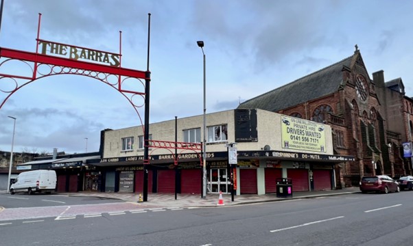 Just before midnight, a high explosive bomb lands at the junction of Kent St and London Rd Glasgow, killing 16 people. In the background you can see the roof of St Alphonsus Church. The site today is where many Glaswegians first savored hot doughnuts at the famous Barras market.