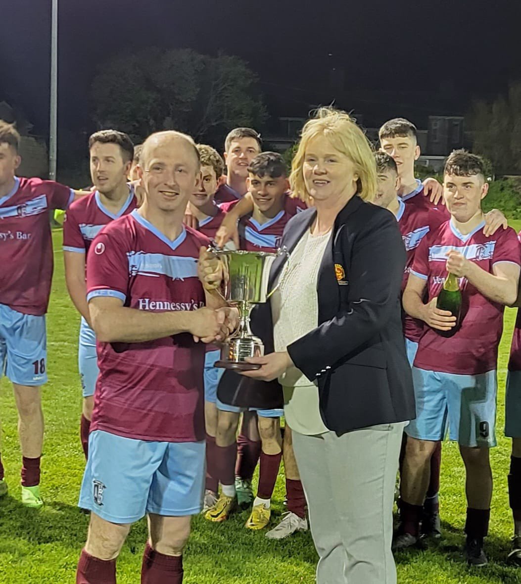 MunsterSenLgue's tweet photo. Congratulations to Youghal Utd who are Beamish Stout Senior 2nd Div Champions following their win tonight. Photo shows 
Youghal Uniteds captain Paul Kelly receiving the Trophy from Paula O’Donnell, MSL. https://t.co/TxS6qMuAut