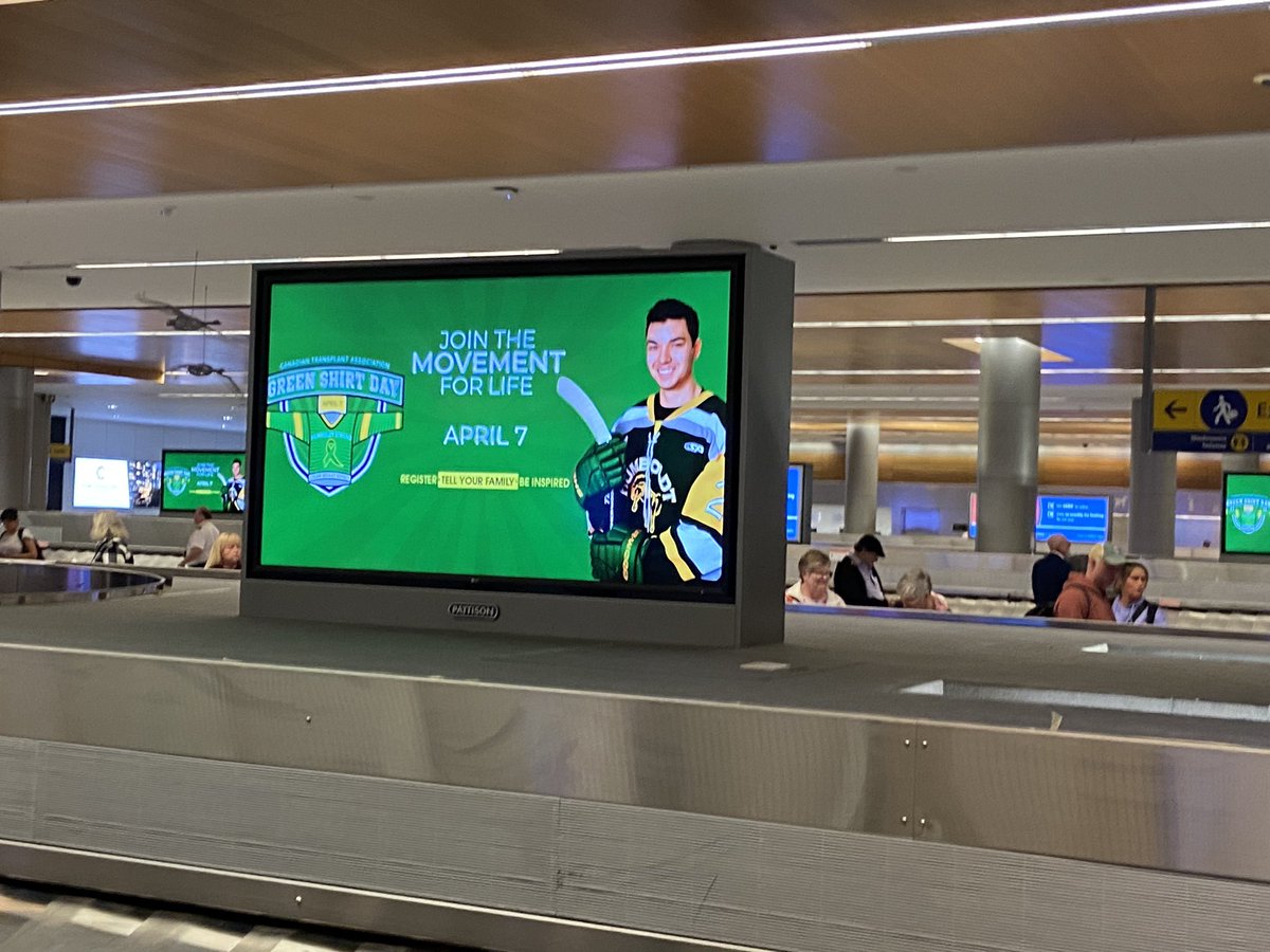 Waiting for our bags at Calgary airport and this shows up on the carousel advertising. #GreenShirtDay