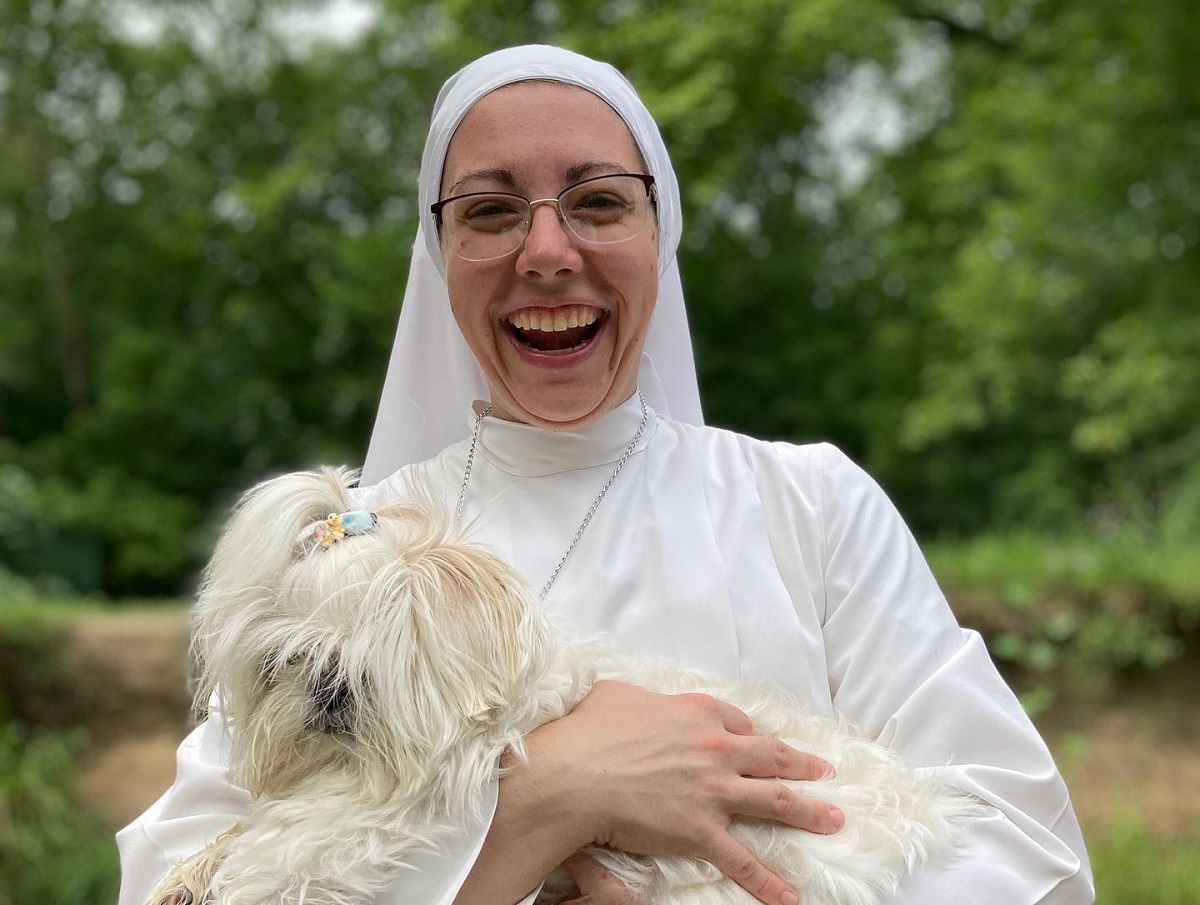 A Religious Sister of the Mercedarian Sisters of the Blessed Sacrament <a href="/MercedarianSrs/">Mercedarian Sisters</a> holding a dog and laughing. Photo from the Sisters' Facebook page at facebook.com/mercedarians/p….