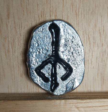 psionronin's tweet image. My second successful metal casting. It's a tin worry stone with the hunter's mark from Bloodborne