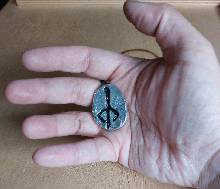 psionronin's tweet image. My second successful metal casting. It's a tin worry stone with the hunter's mark from Bloodborne